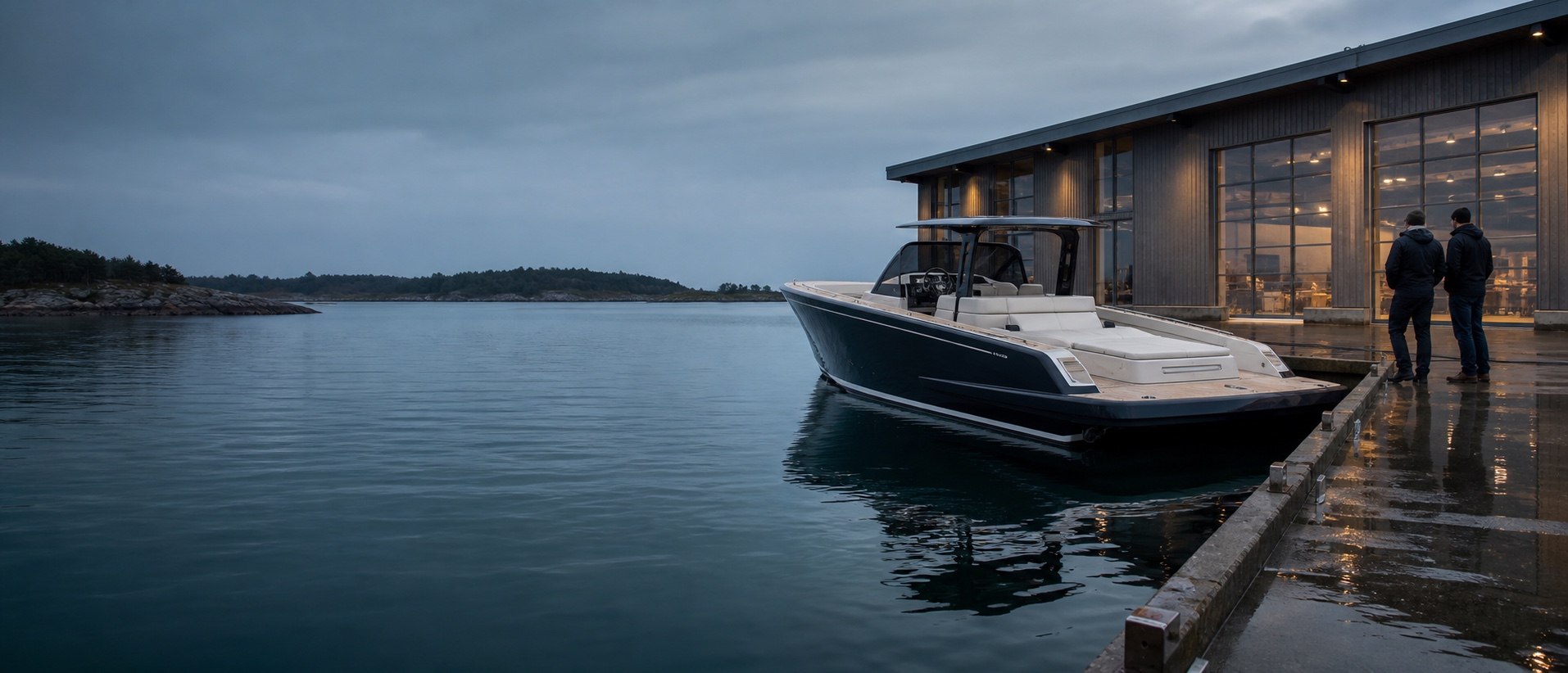 A newly developed premium dayboat beside a modern coastal boatyard with two product founders reviewing it