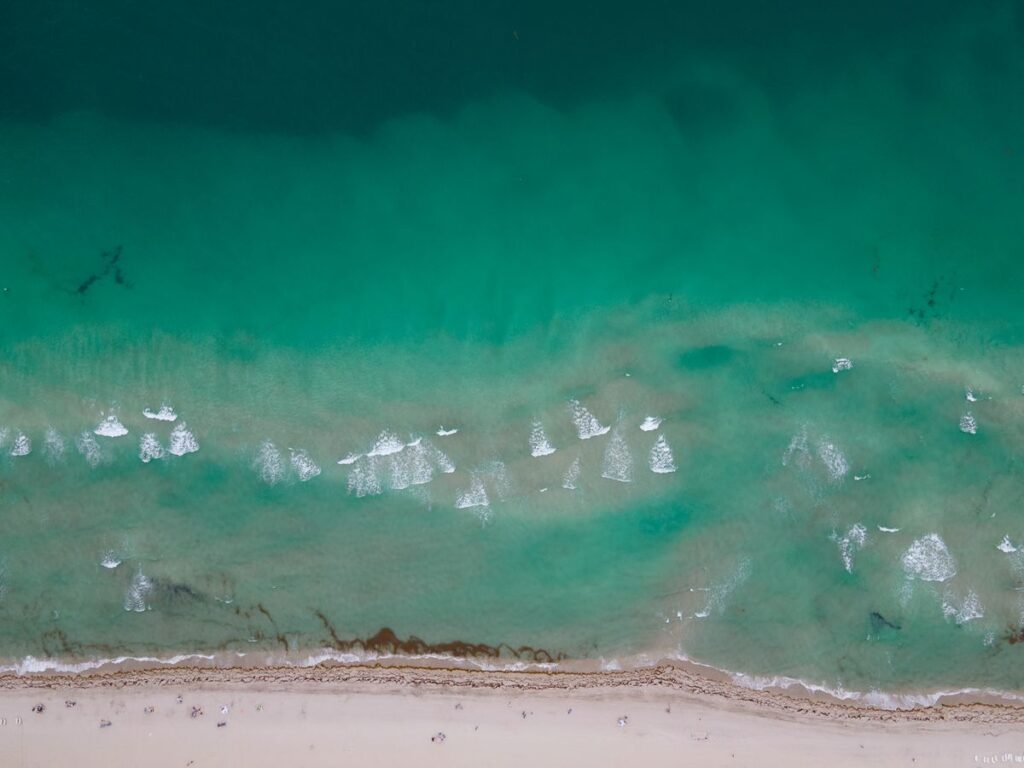 Aerial view of turquoise water and the shoreline at Miami Beach