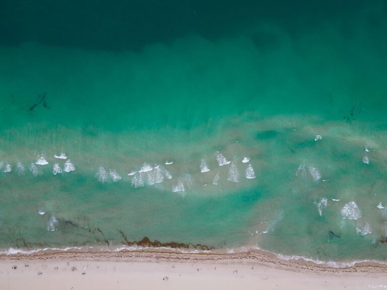 Aerial view of turquoise water and the shoreline at Miami Beach